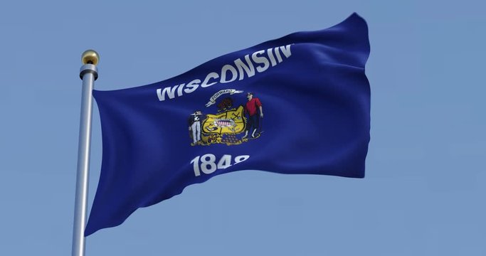 Wisconsin flag blowing in the wind with blue sky