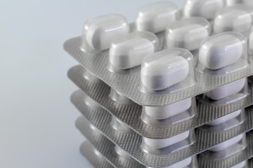 Unopened pills in fabricated medicine plates. Copy space for text.