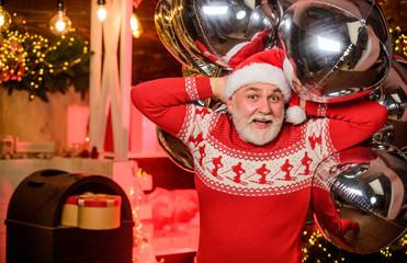 Aero design. Festive balloons. Air balloons. Christmas time. Man senior Santa claus hold silver air...
