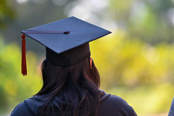 The back of the graduates are walking to attend the graduation ceremony at the university