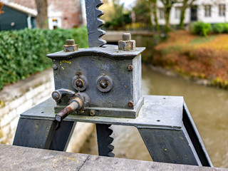 Close up of metal mechanical device used for raising and lowering flood gates