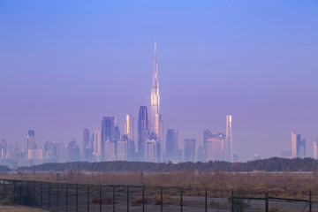 Urban skyline and cityscape at sunrise in Dubai.