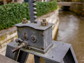  Close up of metal mechanical device used for raising and lowering flood gates