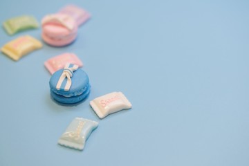 Pastel color fake macaroon  and candy with blue pastel background, Sweet candy concept, Selective focus