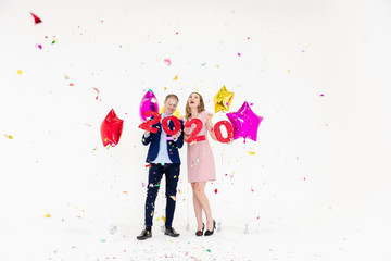Fototapeta na wymiar Young woman and man have fun with Happy New Year.