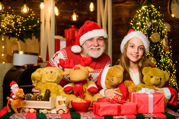 Fototapeta na wymiar xmas happiness and joy. gift for child. family holiday weekend. small girl with santa man. father and daughter love christmas. happy new year. grandfather and grandchild at home