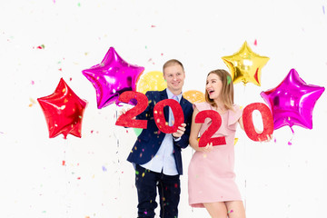 Young woman and man have fun with Happy New Year.