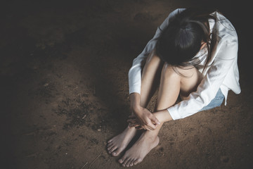  Women sitting on the floor crying with depression, Depressed woman, family problems, Stress, kitchen, abuse, Domestic violence, The concept of depression and suicide.