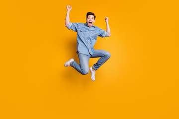 Fototapeta na wymiar Full length body size photo of cheerful positive crazy man jumping up screaming to everyone wearing white sneakers isolated vivid color background