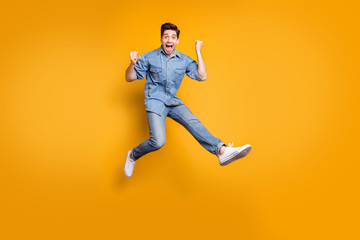 Naklejka na ściany i meble Full length body size photo of cheerful positive overjoyed man excited about having won competitions jumping up isolated vivid color background