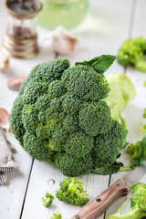 Fresh green broccoli on a white rustic wooden table