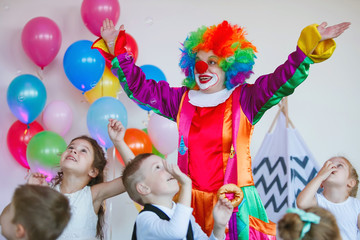 Children play with a clown