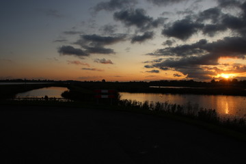 Sunset with colorful sky over the Eendragtspolder, used for water storage to prevent flooding of the city of Rotterdam