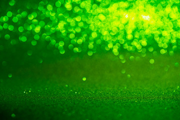 green Sparkling Lights Festive background with texture. Abstract Christmas twinkled bright bokeh defocused