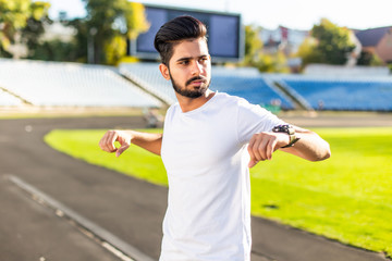 Indian man Athlete is warming up at the stadium. Male athlete is warming up at the stadium....