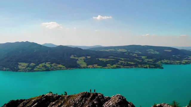 Aerial view of two people standing on top of the Schoberstein summit at the Attersee in Upper Austria, Austria