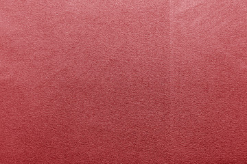 Plastic glittering texture in red color.