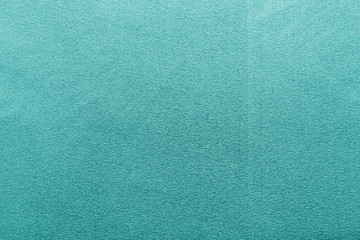 Plastic glittering texture in cyan color.