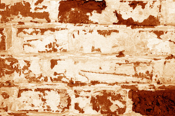 Old grungy brick wall texture in orange tone.