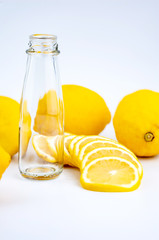The Lemon and lemon slice  and bottles on the white background.