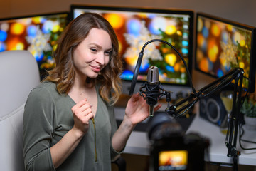 Video blogger, leads a YouTube channel, emotionally talks to the camera with a professional light, and a studio microphone