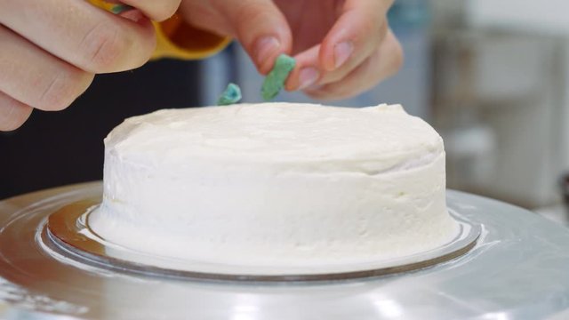Placing toppings on a cake