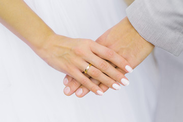 The bride holds the hand of the groom. Wedding engagement ring on your finger