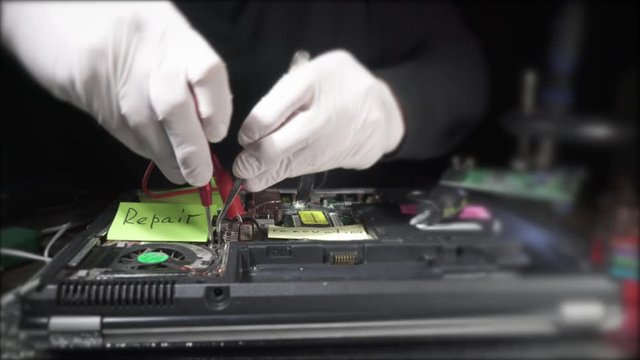 Technician  unscrews computer details with screwdriver. Man repairing broken computer, video card,memory RAM, cooler, processor,hard drive.