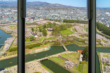 Fototapeta na wymiar Goryokaku Tower Observation Deck command entire view of the park, the beautiful star shaped fort. People come in springtime to enjoy the cherry blossoms full bloom. Hokkaido, Japan