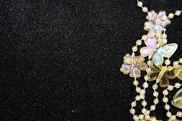 Butterfly and flower garland decoration with space copy on Black glitter background