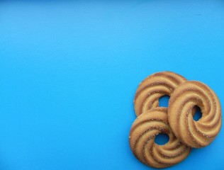 Sweet pastry cake on a blue background with space for text