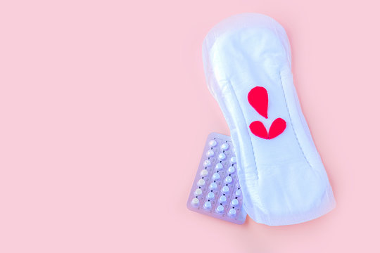Protective menstrual pad and contraceptive pills. The concept of women gynecological health and intimate hygiene. Flat lay, copy space for text, close up