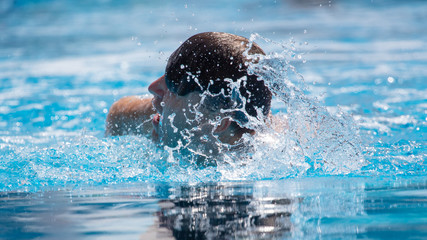 A man is swimming in the pool