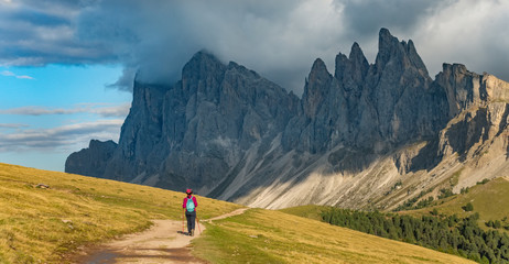 Sporty Young woman on mountain trail Dolomites Mountains, Italy. Sport, success, inspiration