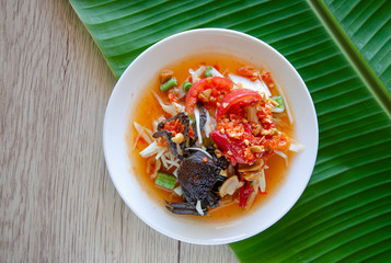 Som Tam Thai - Papaya Salad Thai Food Style on wooden table background. Thai Food Concept. Top View