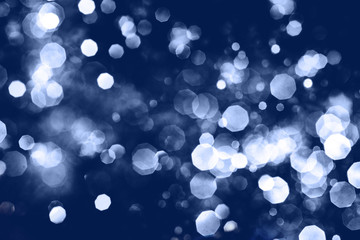 Defocused abstract blue christmas background. Classic blue color of year 2020
