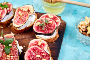 Italian crostini. Bruschetta  or ctostini with cottage cheese, figs and honey. Sandwich with figs and goat cheese.