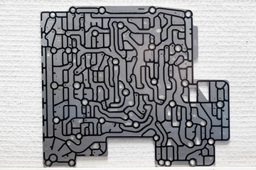 An electronic microcircuit with an aluminum board with black tracks for transmitting information...