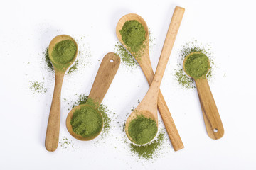 Matcha green tea powder in spoons isolated on white background creative flat lay, Organic product...