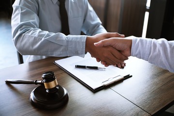 lawyer handshake with client. Business partnership meeting successful concept.