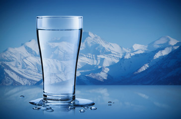 Mineral water in a glass with water drops in the iceberg background, Healthcare and beauty...