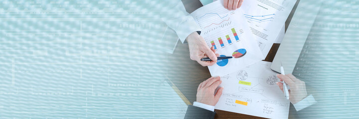 Businesspeople having a discussion about financial report; panoramic banner