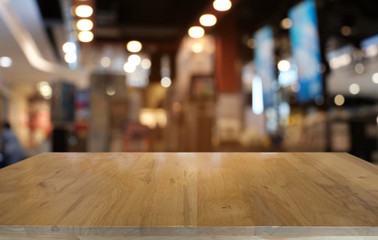 Empty dark wooden table in front of abstract blurred bokeh background of restaurant . can be used for display or montage your products.Mock up for space.