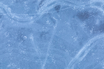 The macro or closeup shot of ice texture or background on the puddle or pool in the frost winter weather