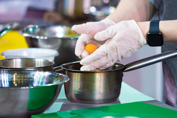 Egg yolk. Cook separates the yolk from the protein. Cook adds egg white to the dish. Concept - learn how to cook. Concept - Culinary University. Recipes with the addition of chicken eggs.