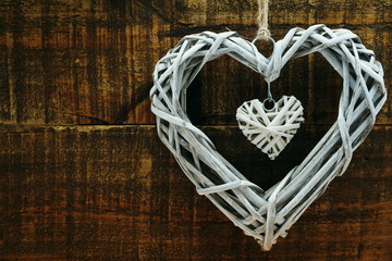 Wicker heart decoration on grunge wooden background valentine's day concept