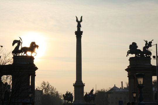 silhouette of Statues and sculptures in Heroes' square monument in sunset in Budapest Hungary