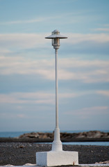 beach lamppost with blue sky and beach