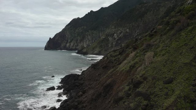 Aerial drone view of stone cliffs, ocean waves and oceanscape.