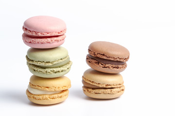 Obraz na płótnie Canvas macaroons in several colors and tastes stacked on a white background